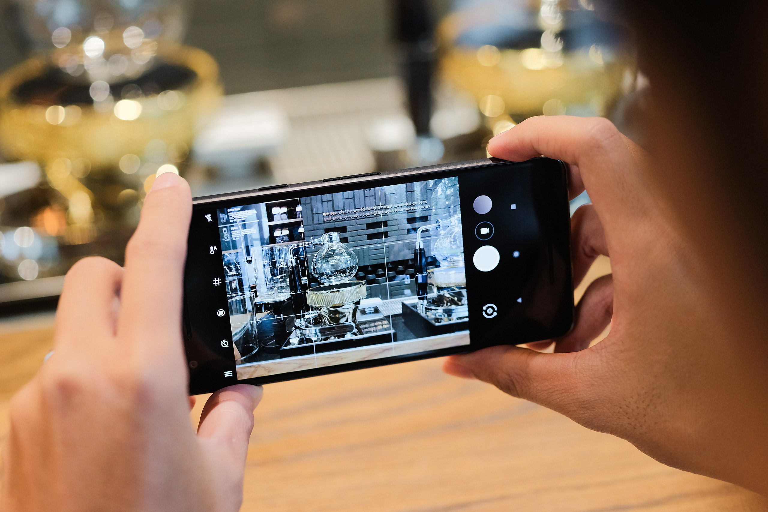 A person takes a photograph on their mobile phone.
