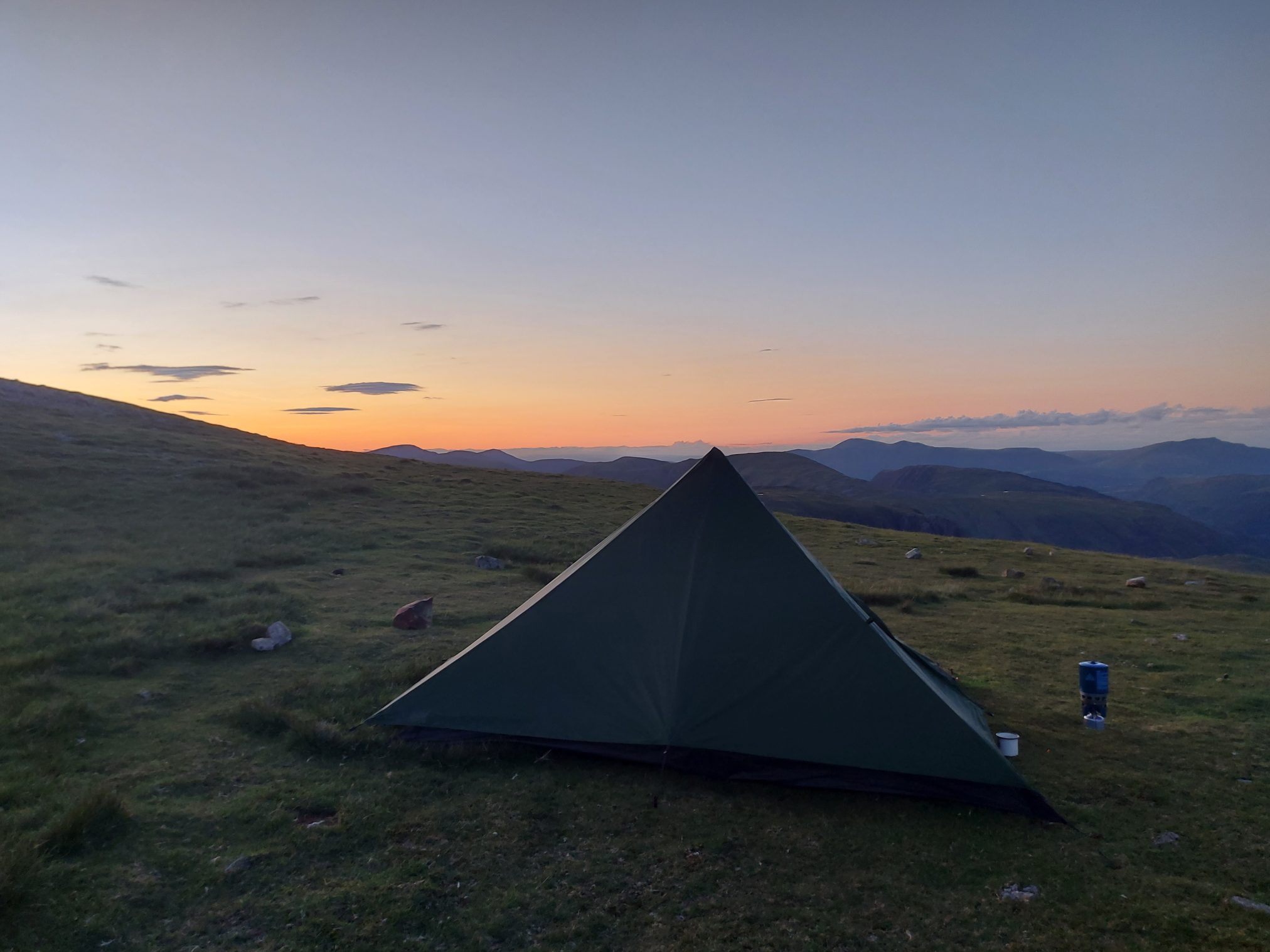 Tent in a Lake District field at sunset.