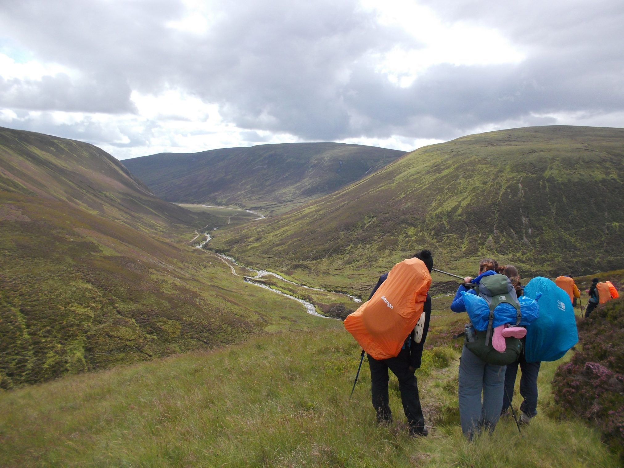 Group of hikers overlooking a Cairngorms valley.
